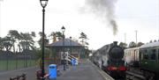 Steam train onn platform at Whitehead Railway Museum