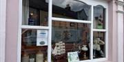 Exterior window display of maritime and drink related collectibles in the Coast Road Inn