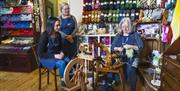 Crafting class - traditional wool spinning with people watching at Lighthouse Yarns