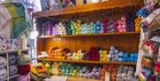Interior of Lighthouse Yarns with multi colour wools displayed on shelves