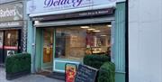 Light green and purple exterior of Delaceys Bakery Cafe in Carrickfergus