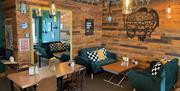 Interior of Digsy's Diner with wooden panel walls, sofas and wooden tables and chairs