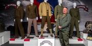 Adrian Hack, tour guide with Lead the Way Tours standing in front of uniformed dummies display at US Rangers Centre in Carrickfergus.