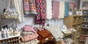 Displays of hand knitted rugs and blankets