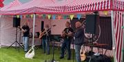 Traditional musicians performing under marquee