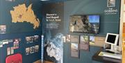 Visitor Information Point at The Gobbins Visitor Centre featuring map of Mid and East Antrim, leaflet display and video screen.