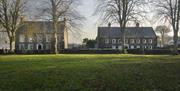 Buildings across green.