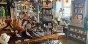 Table, shelf and cupboard display stands with range of items including pottery, jewellery, hats