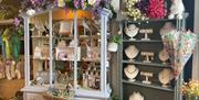 Display unit and shelving with artificial flower surrouds and jewellery and giftware