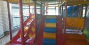 Ludo play area in Carrickfergus Amphitheatre featuring slides and climbing areas