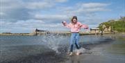 Girl splashing on the beach