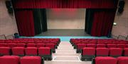 View from seating area of stage with curtains  in McNeill Theatre