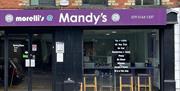 Shop front of Morelli's @ Mandy's with black frames and purple signage.