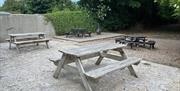 Outdoor wooden picnic tables at rear of Morelli's @ Mandys