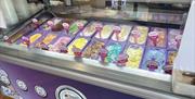 Purple and silver Morelli's Ice cream counter with range of flavoured ice cream displayed