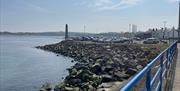 View from Larne Promenade of Chaine Memorial Tower, with car park inbetween.