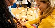 Group admiring their handmade jewellery as part of the jewellery making workshop with Gobbins Crafts in Islandmagee