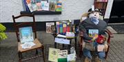 Librarian scarecrow surrounded by books at Gracehill Scarecrow Competition