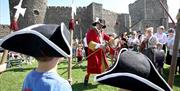 Carrickfergus Castle - crowds of kids and adults in period costumes.