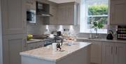 Kitchen with grey cupboards and breakfast bar