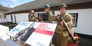 3 men dressed in military gear outside US Rangers Museum