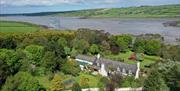 Aerial view of house and grounds showing Larne Lough in the background