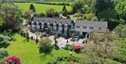 Aerial view of the house and grounds showing lawns to the front of the property