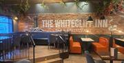 Restaurant area with tables and seats in the Whitecliff Inn, Whitehead