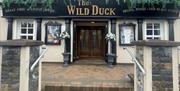 Exterior frontage of Wild Duck Inn in Portglenone with signs up for live music and great food.