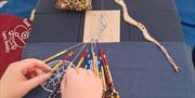 hands working on bobbin lace