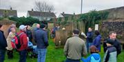Alastair Donaghy leading a Ballymena Walking Tour with tour participants standing in a graveyard