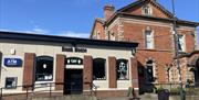 Building exterior of the red brick Bank House Cafe