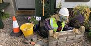 Builder scarecow constructing a brick wall as part of Gracehill Scarecrow Competition