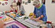 3 ladies learning to wet felt in Midtown Makers workshop space.