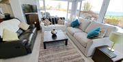 Sitting room area with surround windows and beautiful views.