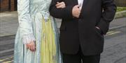 A photo of a couple wearing Victorian costumes