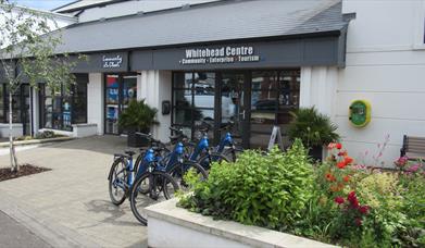 Photograph of Whitehead Centre with e-bikes display in a row.