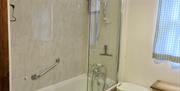 Bath tub with overhead electric shower
