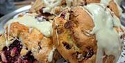 Rasperberry and white chocolate scones displayed on a silver platter
