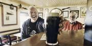 Man enjoying a Guinness in Billy Andys