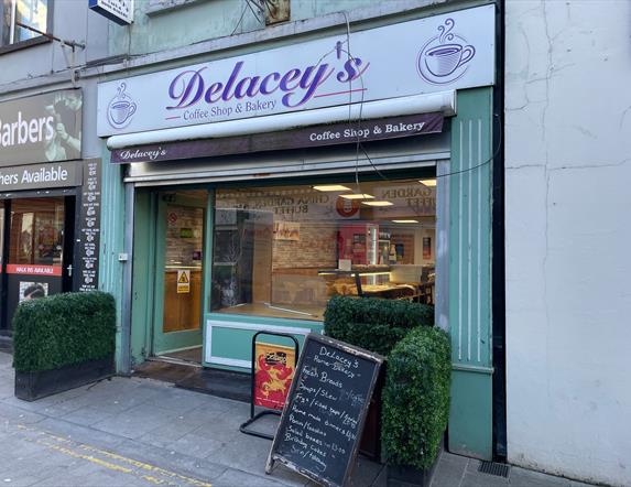Light green and purple exterior of Delaceys Bakery Cafe in Carrickfergus