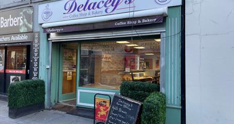 Light green and purple exterior of Delaceys Bakery Cafe in Carrickfergus