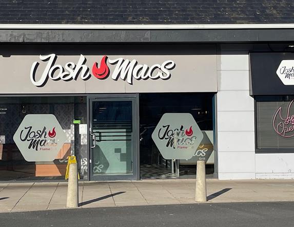 Josh Macs restaurant exterior with sign, large windows and door entrance,