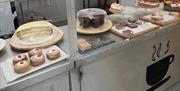 Cakes and buns within a display unit.