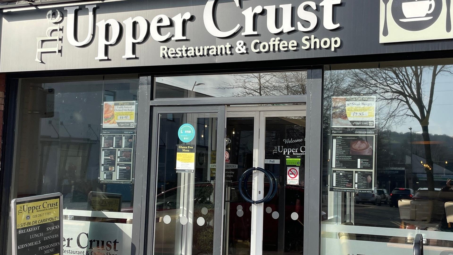 Exterior of Upper Crust restaurant and coffee shop with entrance doors and windows