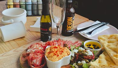 Mixed meat platter with drinks and blank ceramic items