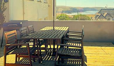 This image shows the south-facing terrace at Little Byfield in Thurlestone, South Devon.  There are stunning sea views. It is sheltered from the wind
