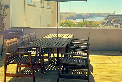 This image shows the south-facing terrace at Little Byfield in Thurlestone, South Devon.  There are stunning sea views. It is sheltered from the wind