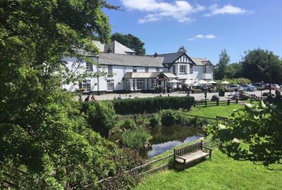 View of the hotel and front gardens on a sunny day