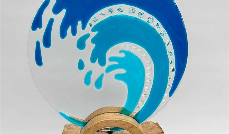 Blue glass wave held in place by wood